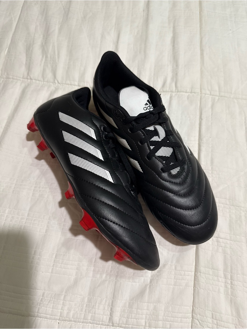 adidas Black Soccer Cleats with White Stripes and Red Studs